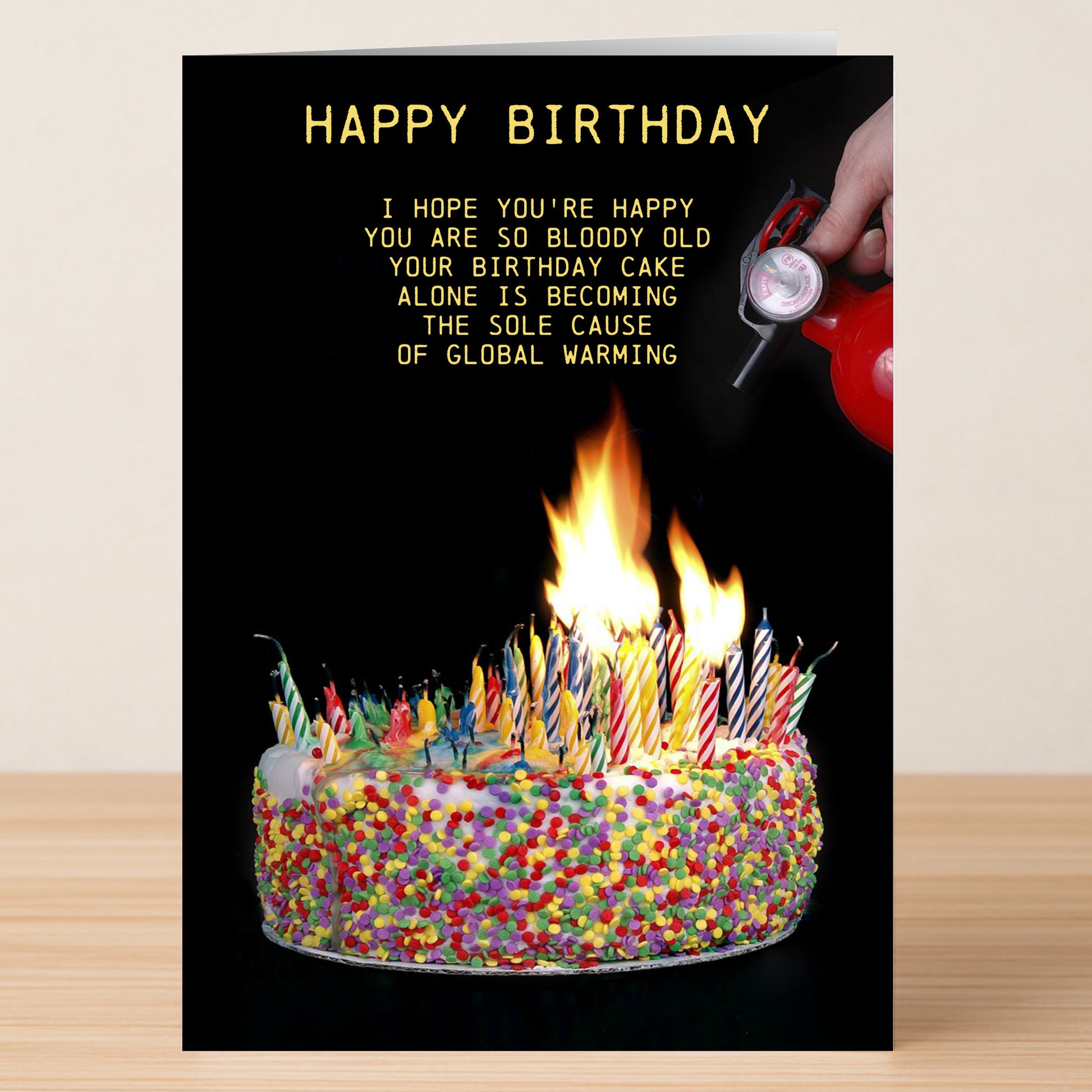 The Candles Funny Birthday Card by Twisted Gifts features a cake loaded with candles, a hand holding a fire extinguisher, and text joking about global warming—making it the perfect humorous birthday card.