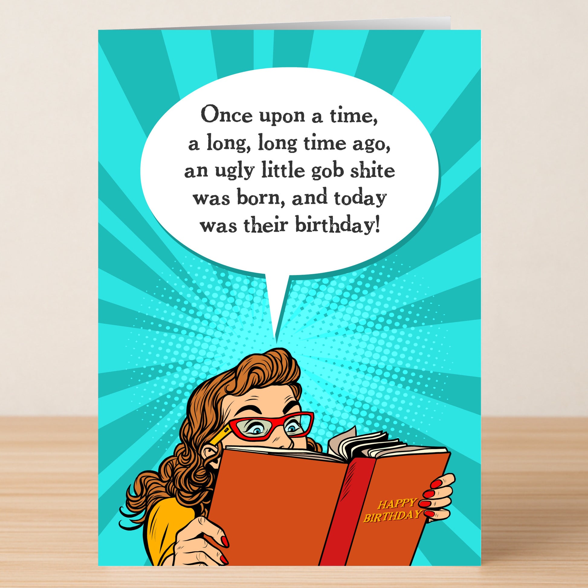 The Gobshite – Insulting Birthday Card by Twisted Gifts features a cartoon woman with red glasses, reading "Happy Birthday," and a cheeky speech bubble—perfect rude banter for someone who can handle an outrageous birthday laugh!.