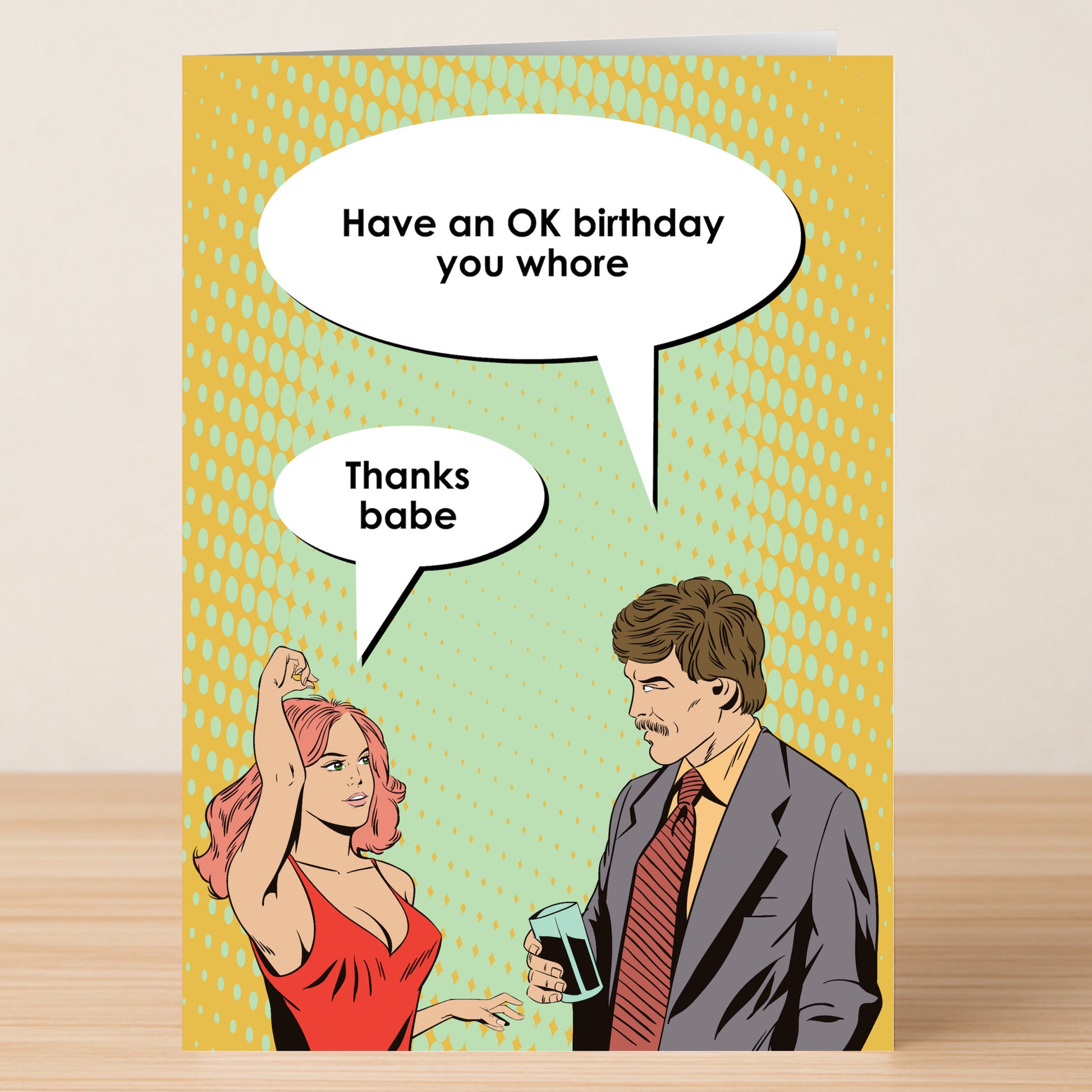 The OK – Insulting Birthday Card by Twisted Gifts features a pop art couple with the cheeky message, “Have an OK birthday you whore” and “Thanks babe.” A hilarious, rude birthday card for friends who enjoy banter.
