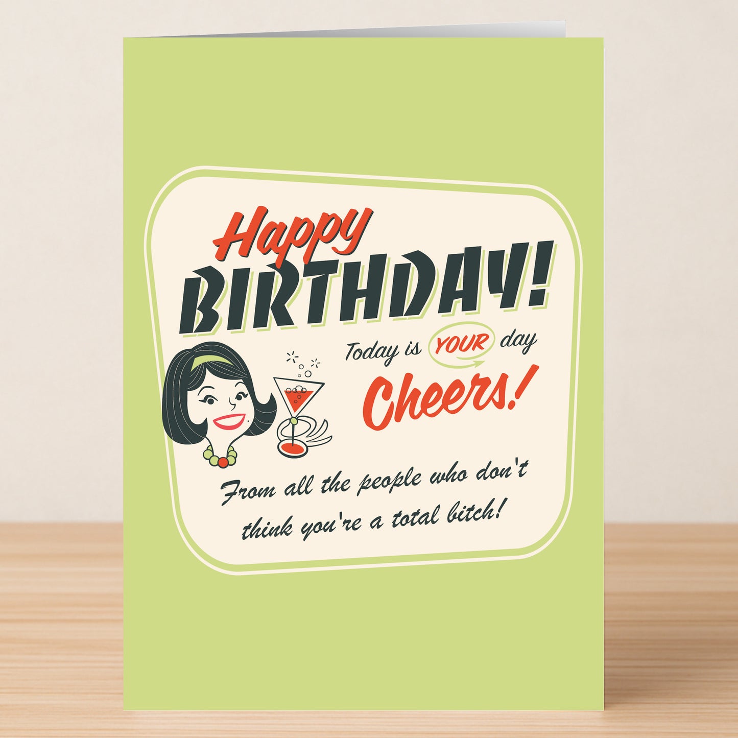 The Today Is Her Day – Insulting Birthday Card by Twisted Gifts features retro-style text and a woman with a cocktail, reading: "Happy Birthday! Today is YOUR day. Cheers! From all the people who don’t think you’re a total bitch!.