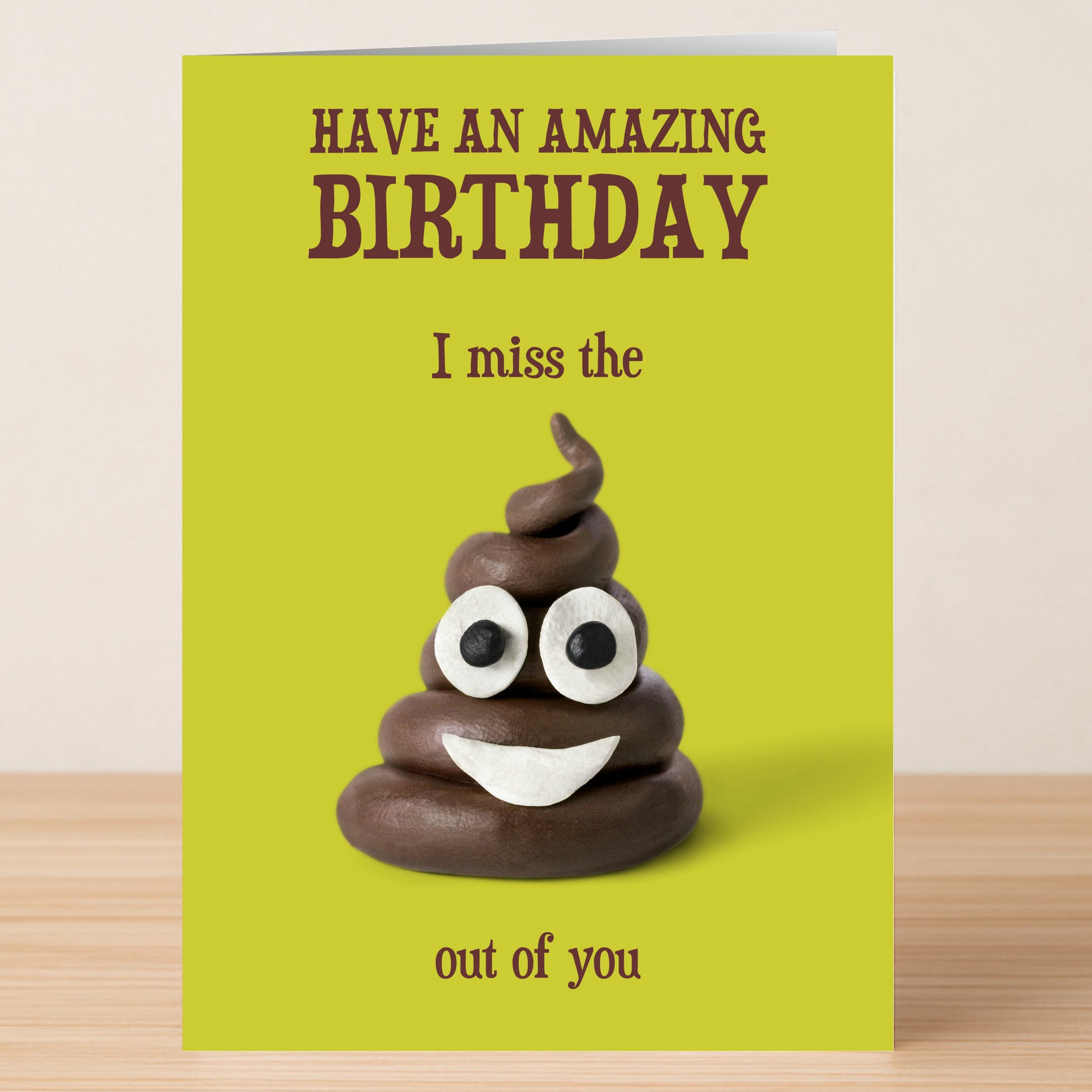 The Miss You – Funny Birthday Card by Twisted Gifts features a smiling clay poop emoji and reads, "Have an amazing birthday. I miss the out of you," playfully implying "shit" without saying it for a cheeky touch.