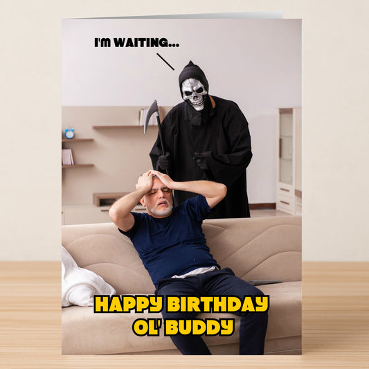 A stressed man sits on a couch as the Grim Reaper looms behind him with "I'M WAITING..." above and bold yellow "HAPPY BIRTHDAY OL' BUDDY" below. Waiting – Funny Birthday Card by Twisted Gifts—ideal for dark humor lovers.