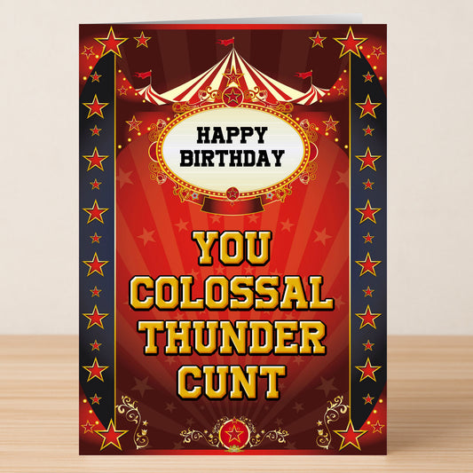 The Colossal – Insulting Birthday Card by Twisted Gifts features bold yellow "HAPPY BIRTHDAY YOU COLOSSAL THUNDER CUNT" text on a circus-themed red background with stars—ideal for fans of funny, offensive birthday cards.