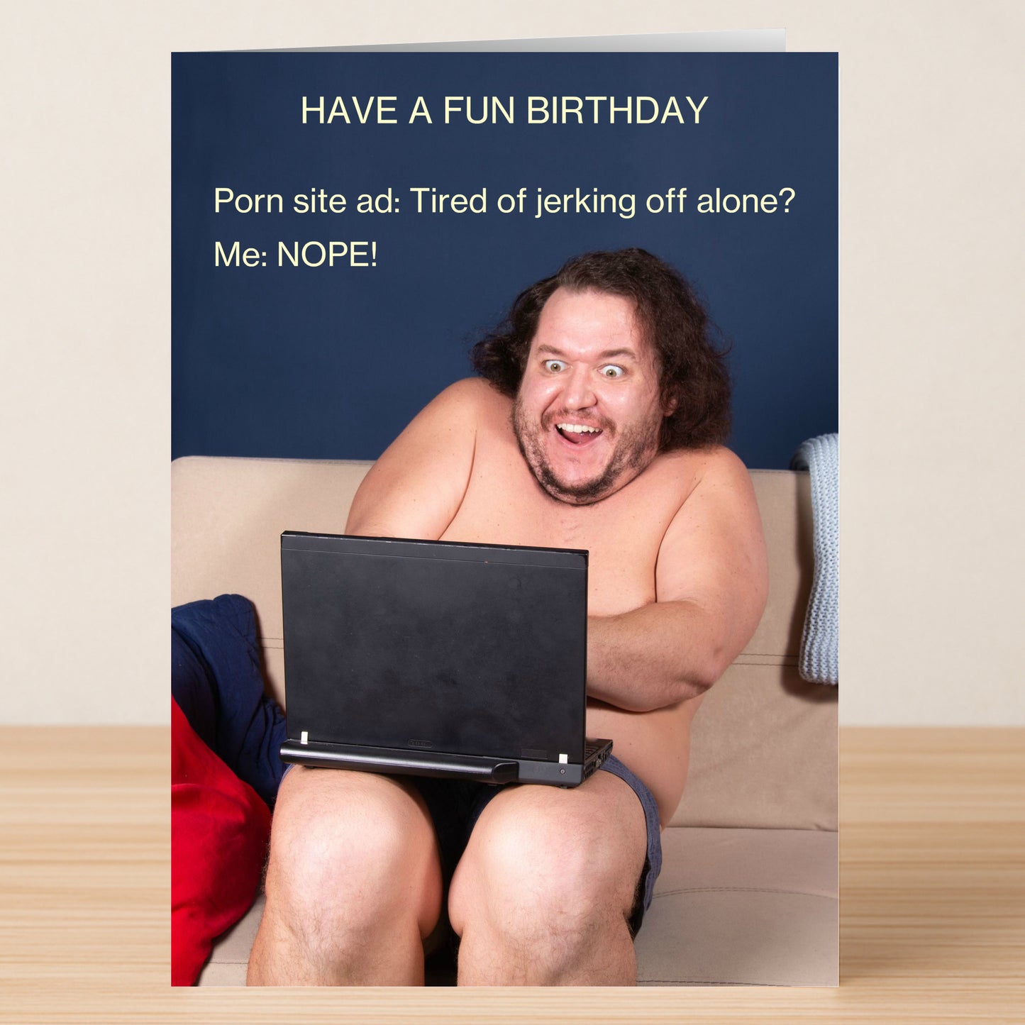 A man sits naked on a couch with just his laptop, smiling widely. The card says "HAVE A FUN BIRTHDAY." Twisted Gifts’ Site Ad – Rude Birthday Card is ideal for those with an edgy sense of humor.
