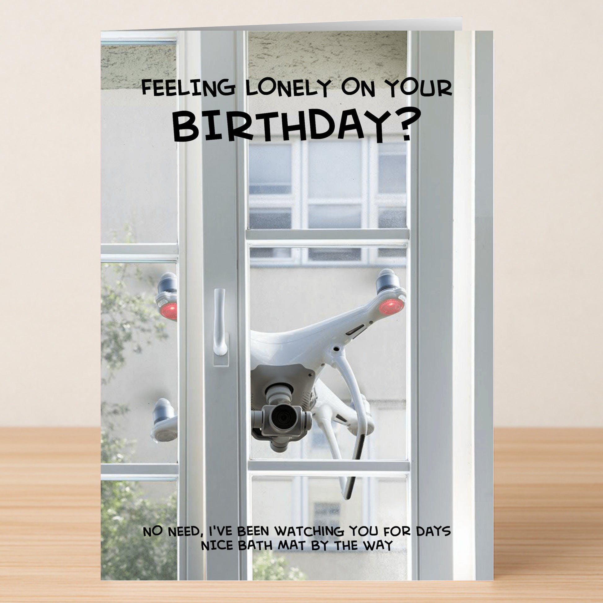 Twisted Gifts’ Bath Mat – Dark Humour Birthday Card features a drone outside a window with witty text, perfect for anyone who loves a laugh and appreciates quirky humor on their birthday.
