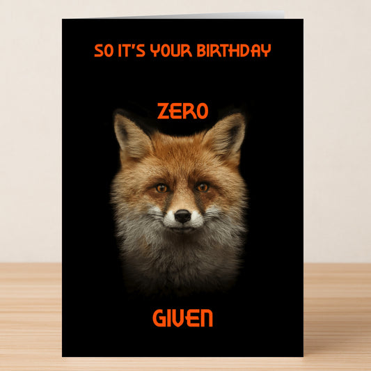 The Zero Fox Given – Funny Birthday Card by Twisted Gifts features a close-up fox on black with bold orange text—ideal for anyone who appreciates an offensive, funny birthday card.
