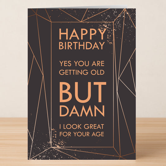 The Looking Good Insulting Birthday Card by Twisted Gifts is a black and gold geometric card that says: "Happy Birthday. Yes you are getting old BUT DAMN I look great for your age.