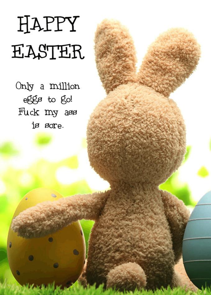 A funny Sore Arse Rude Easter Card by Twisted Gifts is sitting on the grass with easter eggs.