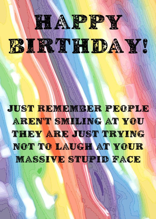 A Twisted Gifts Stupid Face Insulting Birthday Card with a rainbow colored background and black text.