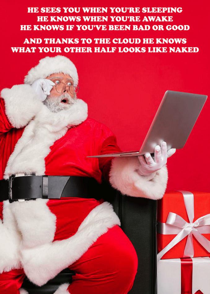 A santa claus sitting on a couch, working on a Twisted Gifts Cloud Rude Christmas Card with a laptop.