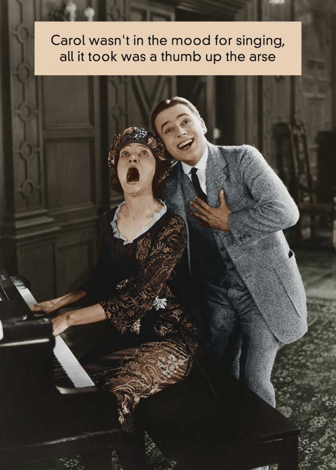 An amusing Twisted Gifts Thumb Rude Greeting Card featuring a man and woman singing at a piano.