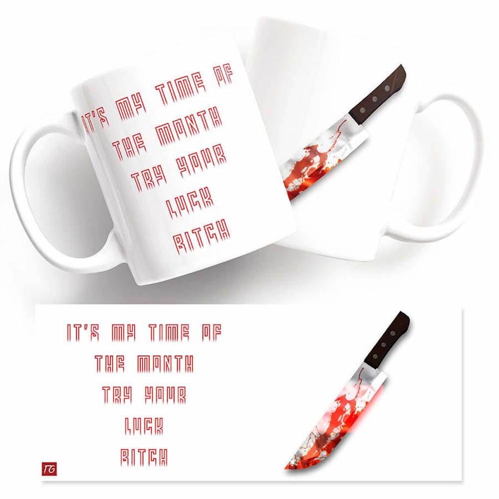 A Time Of Month Mug with a Twisted Gifts - a knife on it.