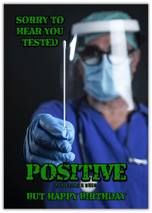 Insulting Birthday Card. Positive doctor in mask and gown holding a swab